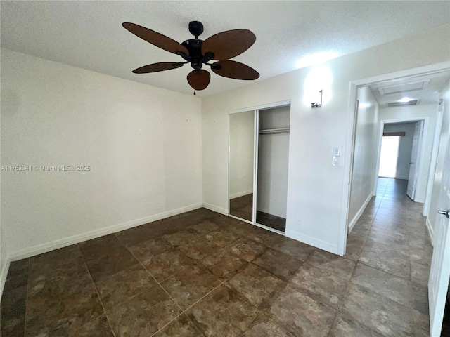 unfurnished bedroom with a closet, baseboards, and a ceiling fan