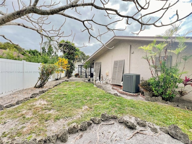 view of yard featuring central air condition unit and a fenced backyard