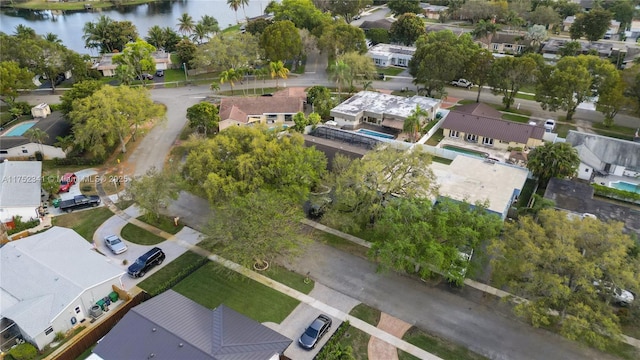 birds eye view of property with a water view and a residential view