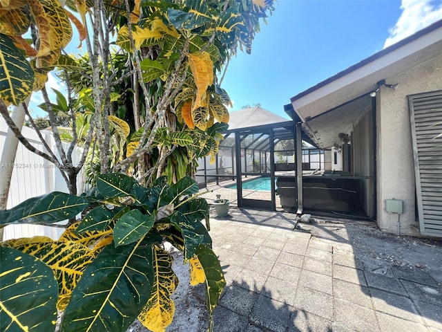 view of patio featuring a lanai, fence, and a fenced in pool