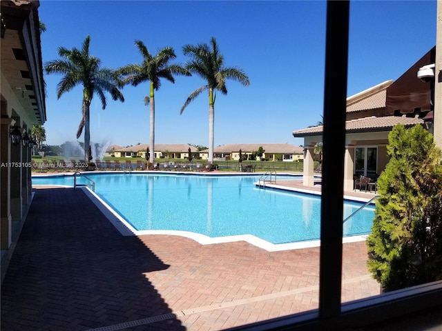 view of swimming pool with a residential view