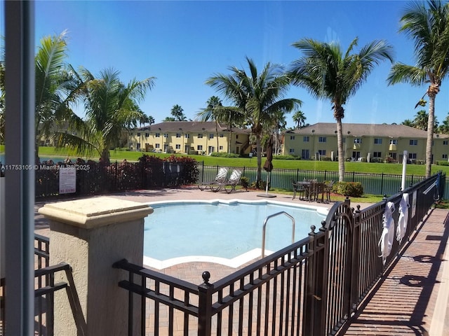 pool with fence and a residential view