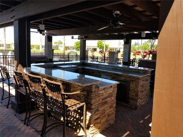 view of patio / terrace with ceiling fan and outdoor wet bar