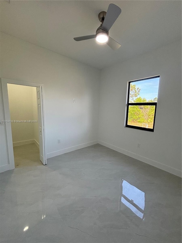 interior space featuring a ceiling fan and baseboards