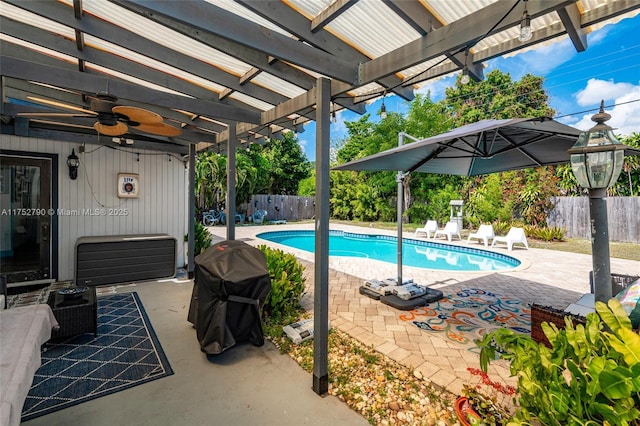 view of swimming pool featuring a fenced in pool, ceiling fan, a patio area, and a fenced backyard