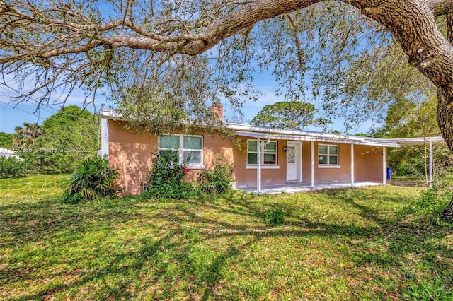 ranch-style house with a front lawn and stucco siding