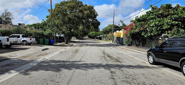 view of street featuring curbs, street lighting, and sidewalks