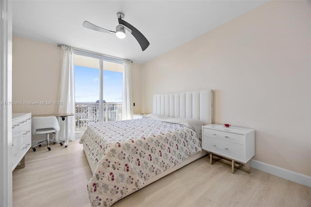 bedroom with access to outside, ceiling fan, a wall of windows, light wood-type flooring, and baseboards