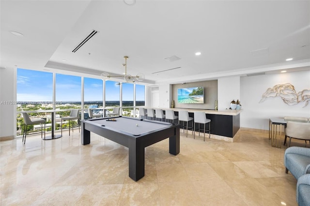 game room featuring billiards, visible vents, a raised ceiling, floor to ceiling windows, and recessed lighting