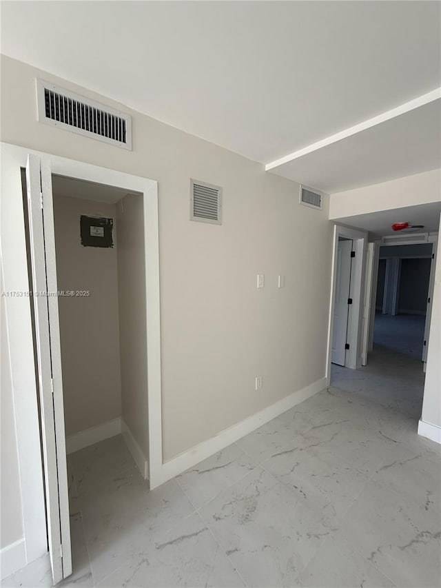 interior space with marble finish floor, baseboards, and visible vents