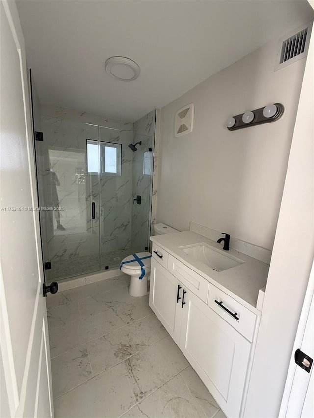 bathroom with marble finish floor, a marble finish shower, visible vents, toilet, and vanity