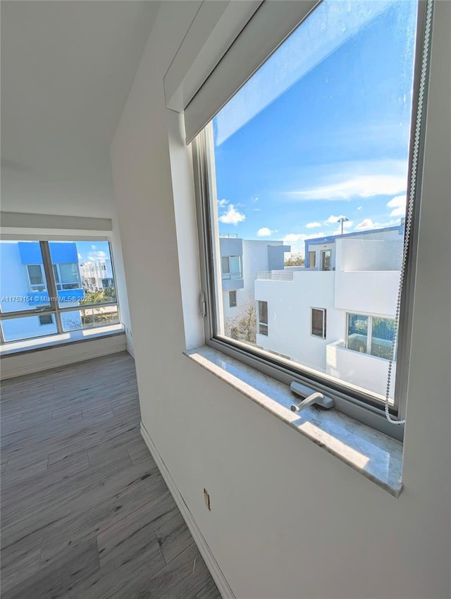 interior space with wood finished floors and baseboards