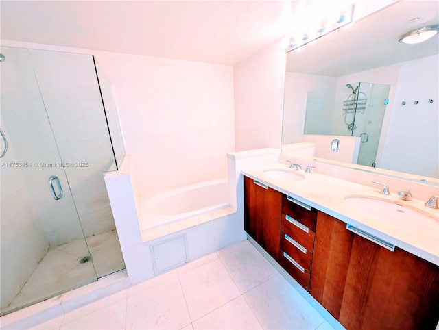 bathroom with a stall shower, tile patterned flooring, a sink, and a bath