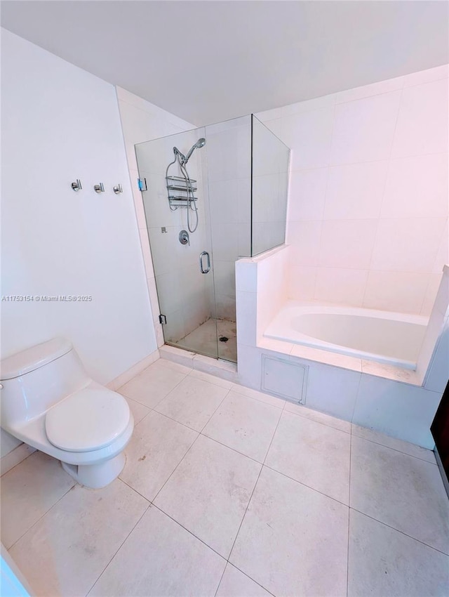 bathroom featuring toilet, a stall shower, a bath, and tile patterned floors