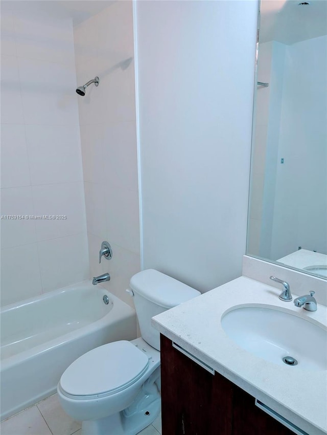 bathroom featuring toilet, tile patterned floors, vanity, and bathing tub / shower combination