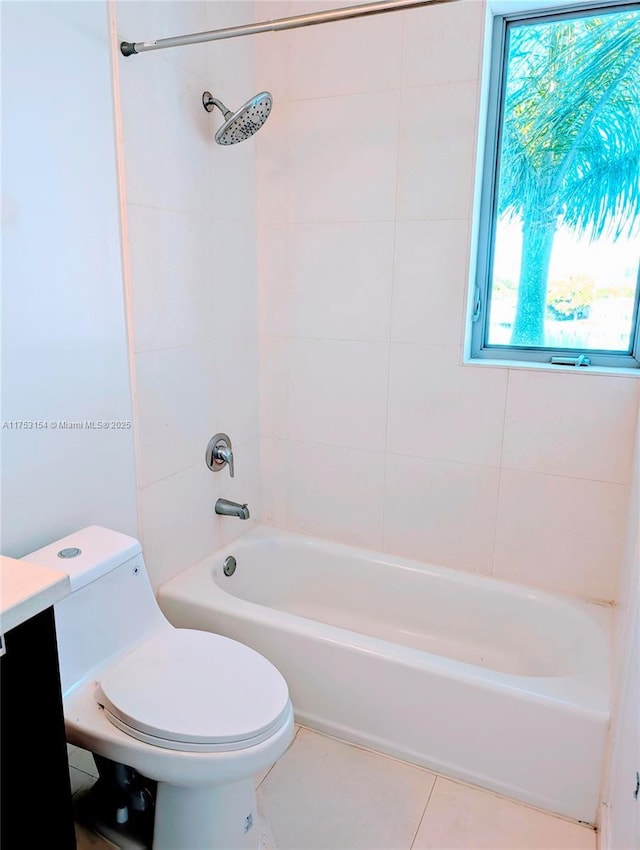 bathroom featuring tile patterned flooring, tub / shower combination, vanity, and toilet