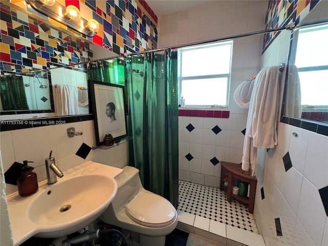 full bath with a wealth of natural light, a stall shower, and tile walls