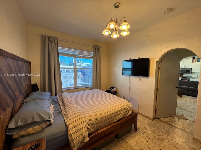 bedroom with arched walkways, visible vents, a textured wall, and baseboards