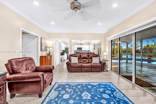 living room featuring light tile patterned floors, ceiling fan with notable chandelier, ornamental molding, and recessed lighting