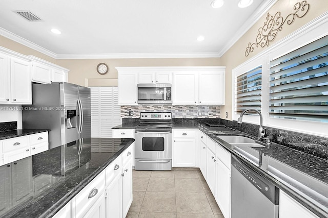 kitchen featuring appliances with stainless steel finishes, visible vents, a sink, and white cabinetry