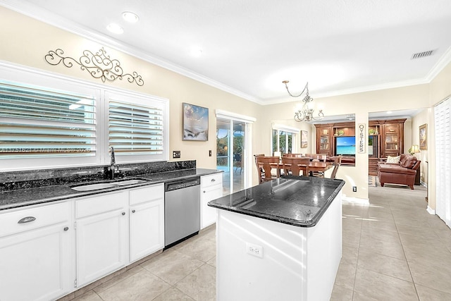 kitchen featuring light tile patterned floors, visible vents, a center island, stainless steel dishwasher, and a sink