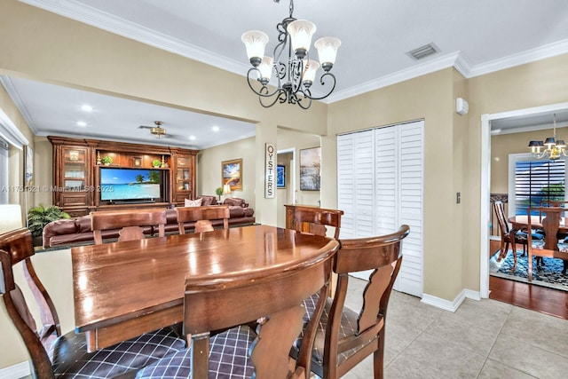 dining space with crown molding, visible vents, a notable chandelier, and light tile patterned flooring