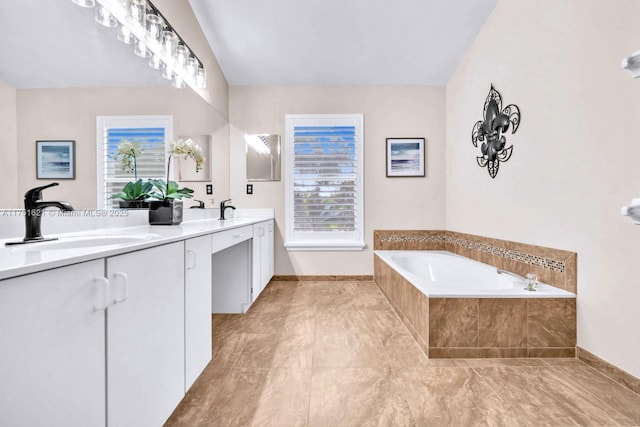 full bath with lofted ceiling, double vanity, a sink, and a bath