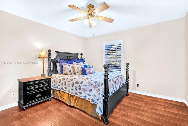 bedroom with ceiling fan, baseboards, and wood finished floors