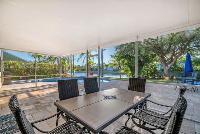 sunroom / solarium with a water view