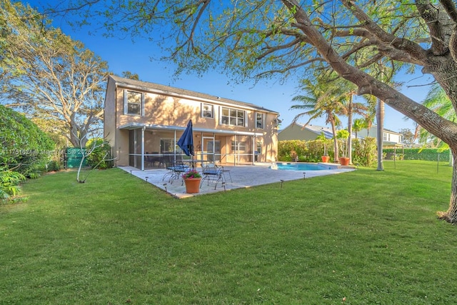 rear view of house featuring a yard, a patio, stucco siding, a sunroom, and an outdoor pool