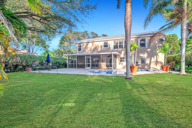 back of property featuring a sunroom, a patio area, and a yard