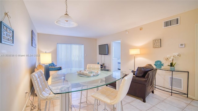 dining space with visible vents, baseboards, and light tile patterned flooring