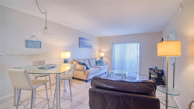 living room with light tile patterned flooring and baseboards