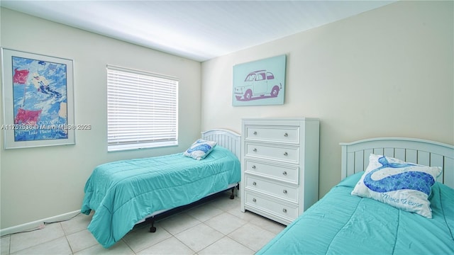 bedroom featuring tile patterned flooring and baseboards