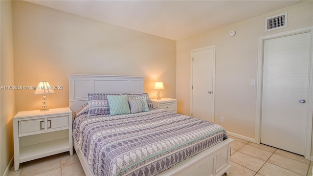 bedroom featuring visible vents, baseboards, and light tile patterned floors