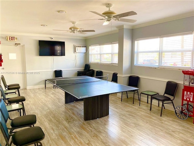 playroom with baseboards, ornamental molding, a wall mounted air conditioner, and light wood-style floors