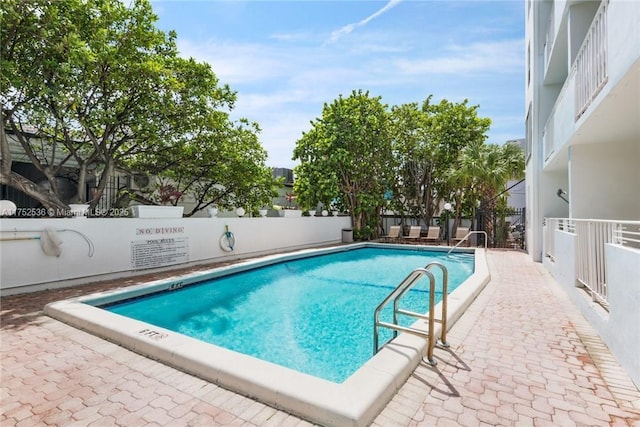 pool featuring a patio area and a fenced backyard