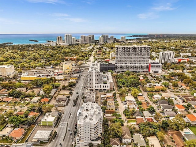 birds eye view of property with a water view and a city view