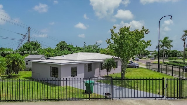 view of front of property featuring a fenced front yard, a front lawn, and stucco siding