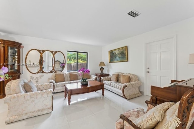 living room featuring light tile patterned flooring and visible vents