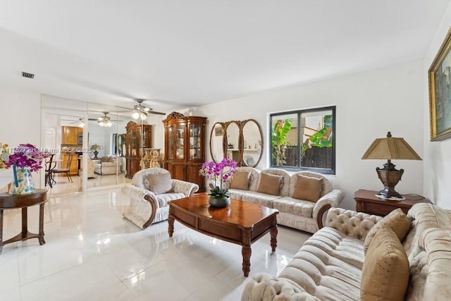 living room with visible vents and a ceiling fan
