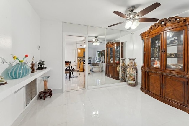 hallway featuring baseboards and tile patterned floors