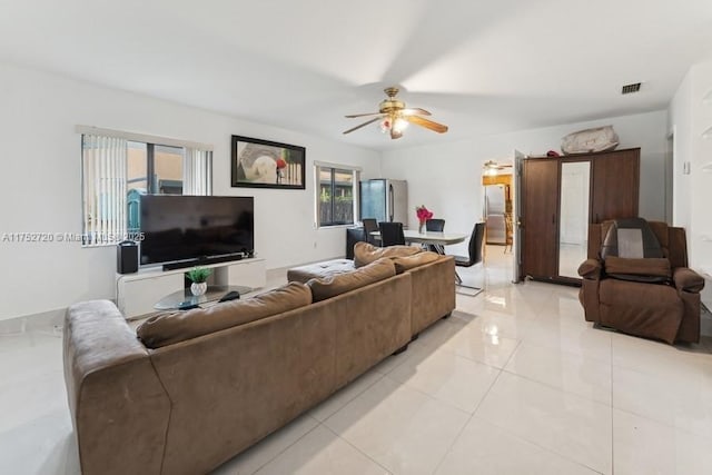 living room with visible vents, ceiling fan, and light tile patterned floors