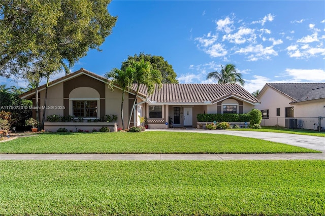 single story home with driveway, a tile roof, central air condition unit, a front yard, and stucco siding