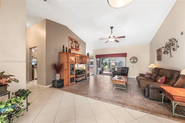 living area featuring high vaulted ceiling, light tile patterned flooring, and ceiling fan