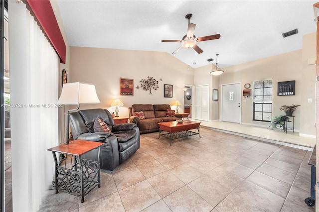 living area featuring light tile patterned floors, lofted ceiling, visible vents, baseboards, and a ceiling fan