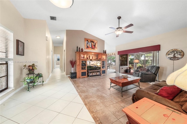 living room with light tile patterned floors, visible vents, baseboards, vaulted ceiling, and a ceiling fan