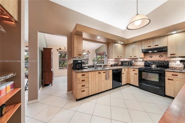 kitchen with lofted ceiling, under cabinet range hood, light brown cabinetry, black appliances, and backsplash