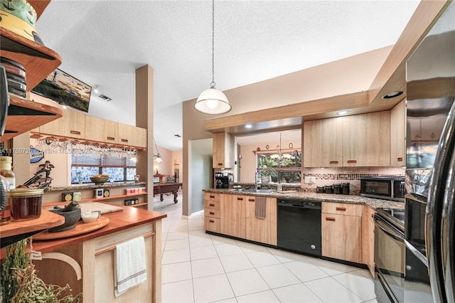 kitchen with light tile patterned floors, a textured ceiling, hanging light fixtures, light brown cabinetry, and black appliances