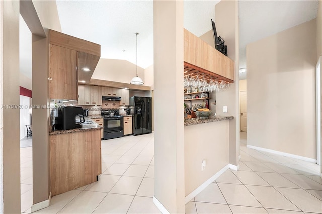 kitchen with light tile patterned flooring, under cabinet range hood, backsplash, dark stone counters, and black appliances